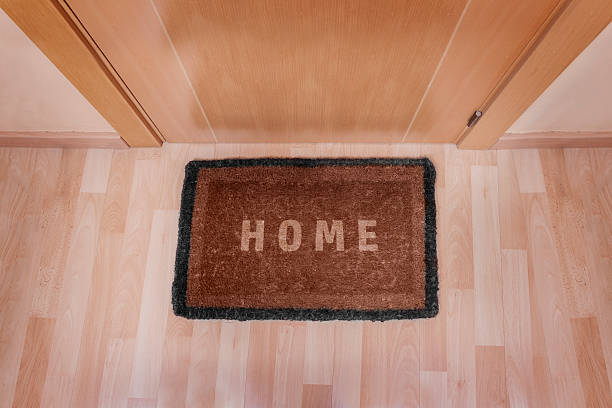 istock Welcome home doormat with closed door 494263519