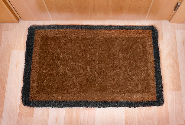 istock Welcome home doormat with closed door 494275875