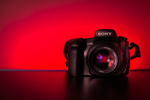 İzmir, Turkey - May 26, 2014: Turkey İzmir - May 26, 2014: Product shot of the A350 Sony DSLR camera body with the 50mm minolta f/1.4 lens. with red background.