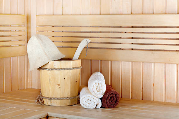 Traditional wooden sauna for relaxation with bucket of water Traditional wooden sauna for relaxation with bucket of water and set of clean towels finnish culture stock pictures, royalty-free photos & images