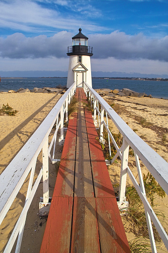 Brant Point Lighthouse on Nantucket Ma with blue skies and grey clouds
