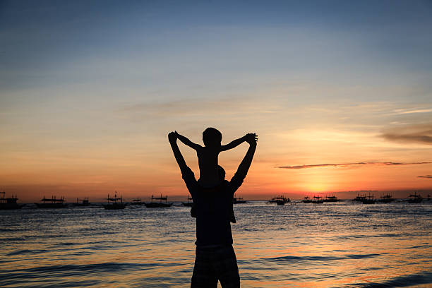 istock happy family on sunset beach 494278987