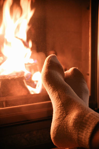 istock female legs near the fireplace 494279002