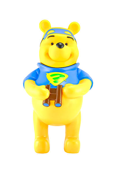 Winnie the Pooh hold a binocular. Bangkok,THAILAND - May 11, 2014 : Figure of Winnie the Pooh hold a binocular. Winine the Pooh is animation from Disney. winnie the pooh photos stock pictures, royalty-free photos & images
