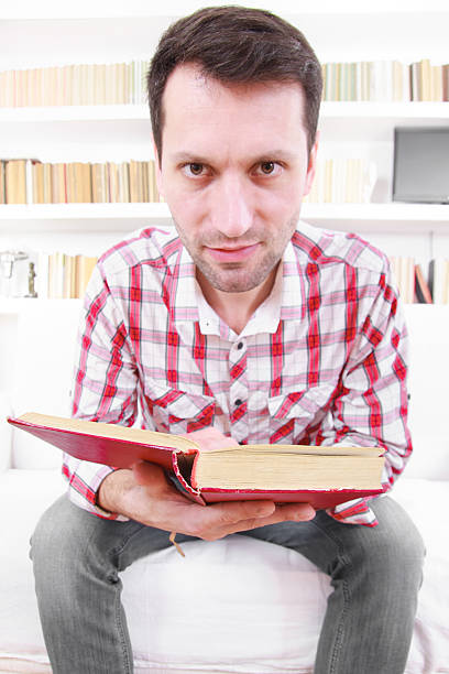 istock crazy male student or professor with book in hands 494279785