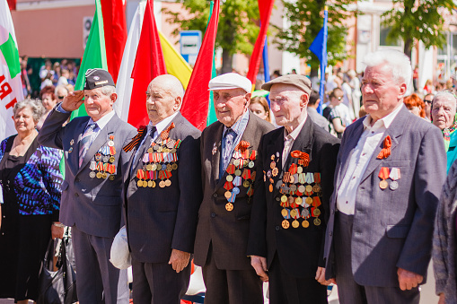 Gomel, Belarus - May 9, 2013: Unidentified veterans standing listen to the Belarus hymn during the celebration of Victory Day on May 9, 2013 in Gomel, Belarus.