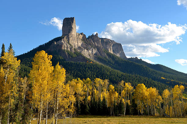 Chimney Peak Chimney Peak rock formations, 11,781 ft (3,591 m), surrounded by golden yellow fall aspen trees, by the summit of Owl Creek Pass, 10,114 ft (3,083m). ridgeway stock pictures, royalty-free photos & images