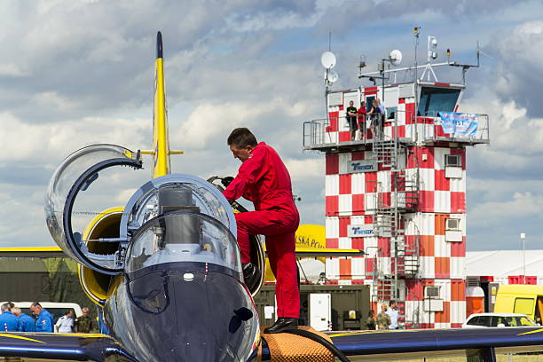 Baltic Bees Jet Team crew with L-39 planes on runway Hradec Kralove, Czech republic - September 5, 2015: Crew of the Baltic Bees Jet Team with L-39 Albatros planes standing on runway at Czech international air festival on September 5, 2015 in Hradec Kralove, Czech republic. aero l 39 albatros stock pictures, royalty-free photos & images