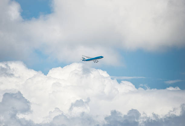 KLM Airline Banking In the Clouds Maho Beach, St Maarten, Netherlands - May 16, 2014: KLM (Royal Dutch Airlines)Boeing 747-400.   Banking in the clouds just after take off from St Maarten, the Dutch side of St. Martin, Caribbean Islands klm stock pictures, royalty-free photos & images