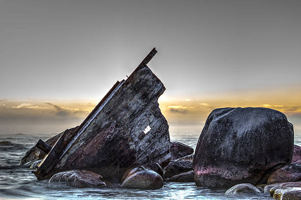 Wooden shipwreck beached on the rocky shore.  Lexington County Park.  Lexington, Michigan.