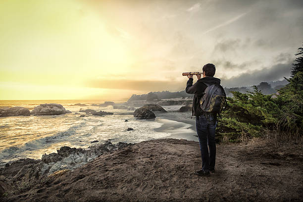 istock Woman with spyglass looking toward ocean 494283872