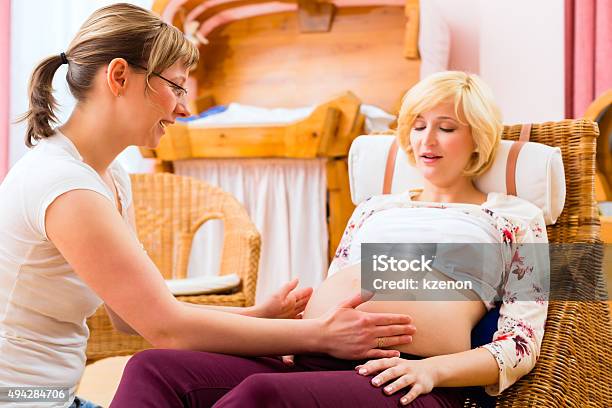 Midwife Seeing Mother For Pregnancy Examination Stock Photo - Download Image Now - Midwife, Examining, Pregnant