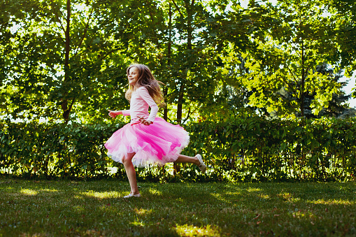 happiness, cute little girl running in the park