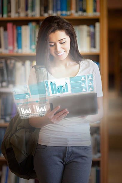istock Smiling pretty student working on her futuristic tablet 494295945