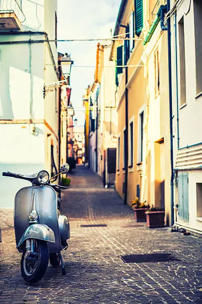 Italian urban scene with a Vespa, a very typical italian motorcycle