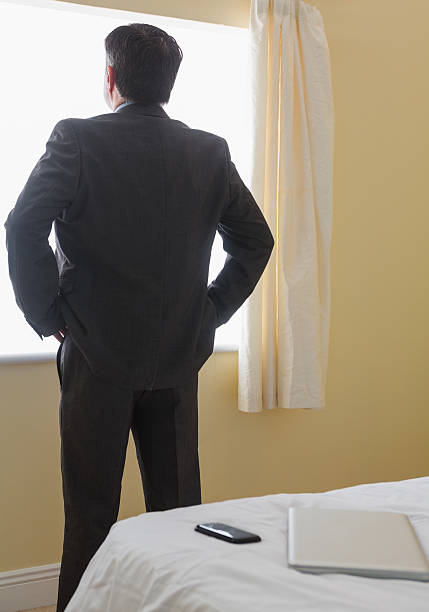 istock Man standing in front of window 494299625