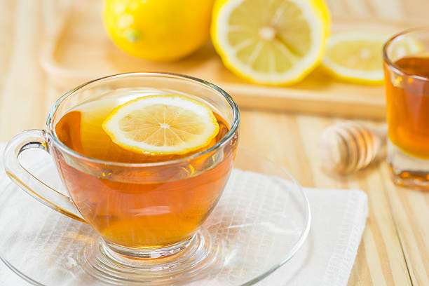 istock tea with  honey  and lemon on wood background,warm toning 494307436