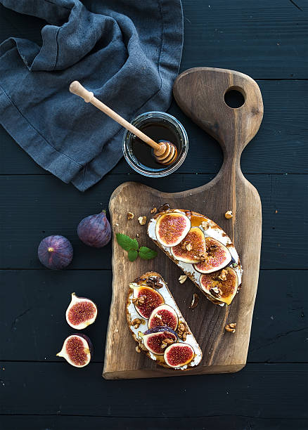 istock Sandwiches with ricotta, fresh figs, walnuts and honey on rustic 494309492
