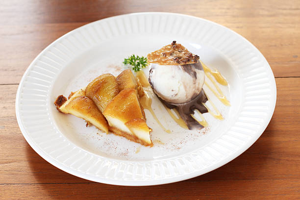 warm apple tart with ice cream on white plate