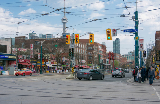 Toronto,Canada - May 19, 2014: General view of China Town with the CN Tower in the image. Chinatown a tourist attraction and busy markets in Ontario. China town is one of the largest in North America