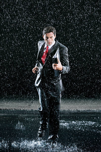 istock Businessman With Binder Running In Rain 494311679