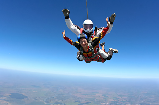 Tandem jump. The girl with the instructor in freefall.