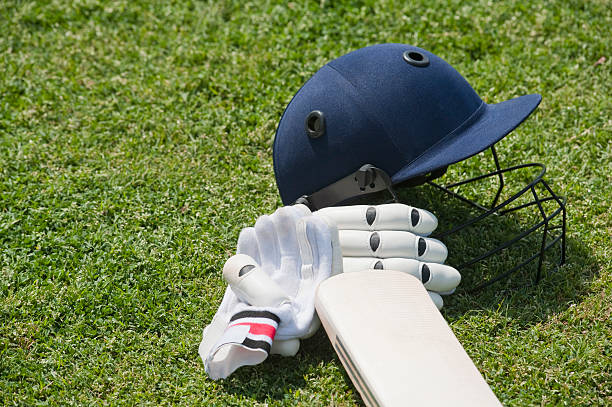 istock Cricket batting gears in a field 494312538