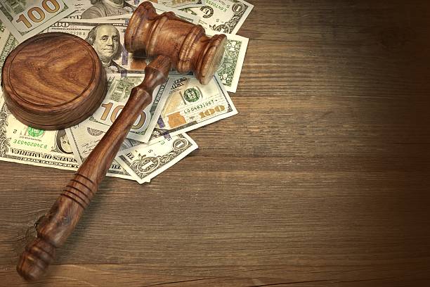 Judges or Auctioneer Gavel And Money On The Wooden Table stock photo