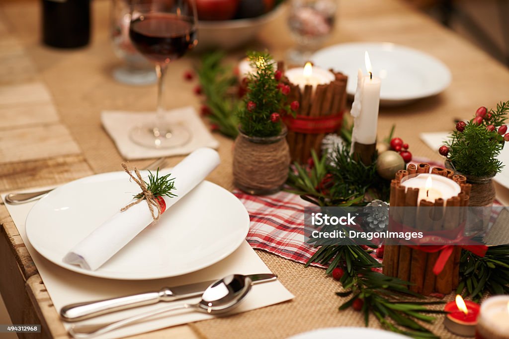 Christmas table decoration Decoration of Christmas table: candles, juniper branches and napkins 2015 Stock Photo