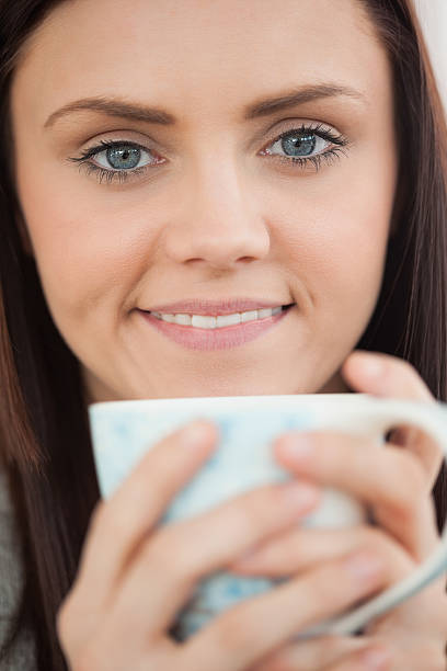 istock Smiling girl holding a cup of coffee 494313241