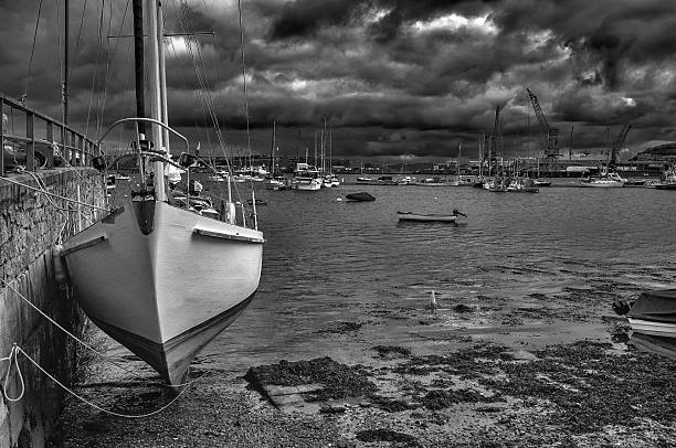 Black and white shot of a yacht in Falmouth Harbour Cornwall