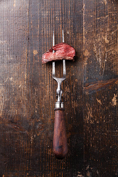 istock Piece of beef steak on meat fork 494314525