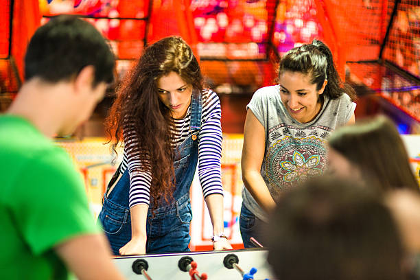 istock friends playing foosball at the arcade game 494314920