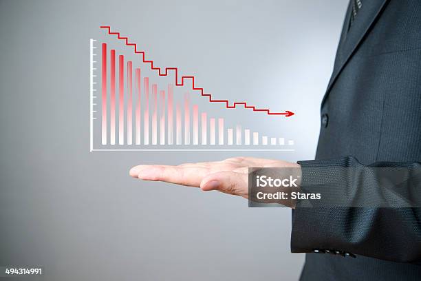 Businessman Presenting A Sustainable Decrease Development Stock Photo - Download Image Now