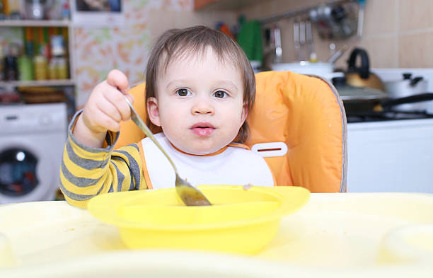 istock lovely baby with spoon 494315109