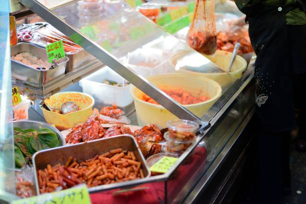 Koreatown Osaka, Japan - May 5, 2014: A food stall selling kimchi and other korean delicacies in one of the narrow alleys of Osaka's Koreatown. banchan stock pictures, royalty-free photos & images
