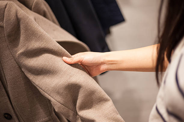 istock Woman's Hands Selecting Winter Coat in Fashion Store 494316224