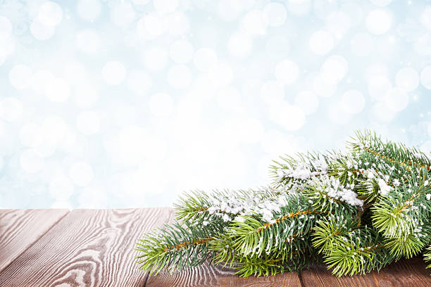 istock Christmas tree branch on wooden table 494316436