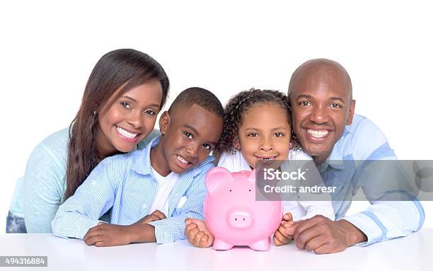 Family With Their Savings In A Piggybank Stock Photo - Download Image Now - Savings, Family, Child