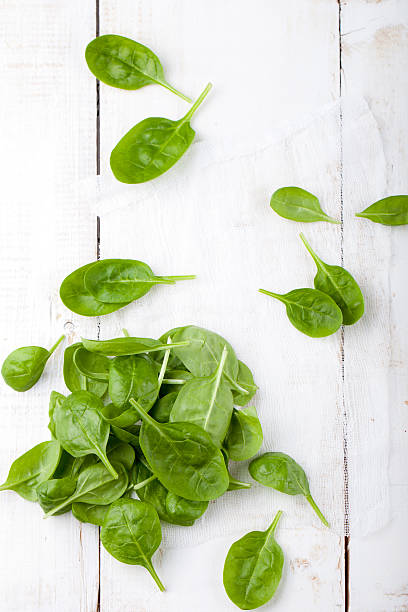 istock Spinach baby leaves on a white wooden background. 494317426