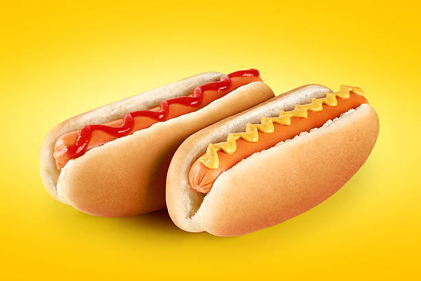 istock Hot dogs with ketchup and mustard on a yellow background. 494317722