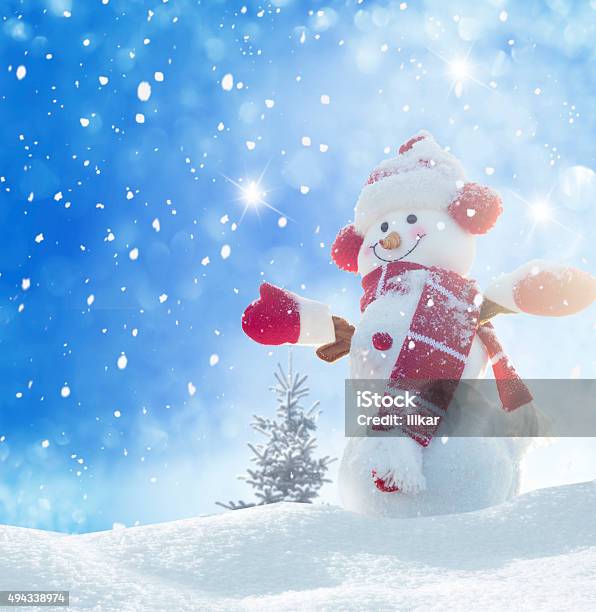 Happy Snowman Standing In Winter Christmas Landscape Stock Photo - Download Image Now