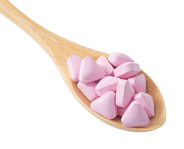 istock Wooden Spoon Full with Vitamins on White Background 494339468