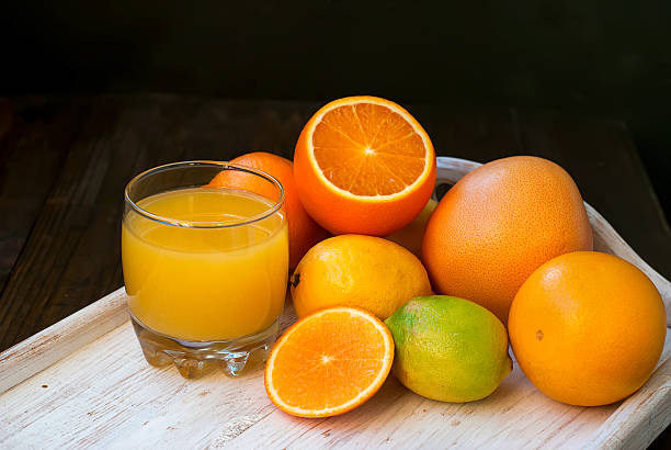 istock Fresh orange juice on wooden table 494340454