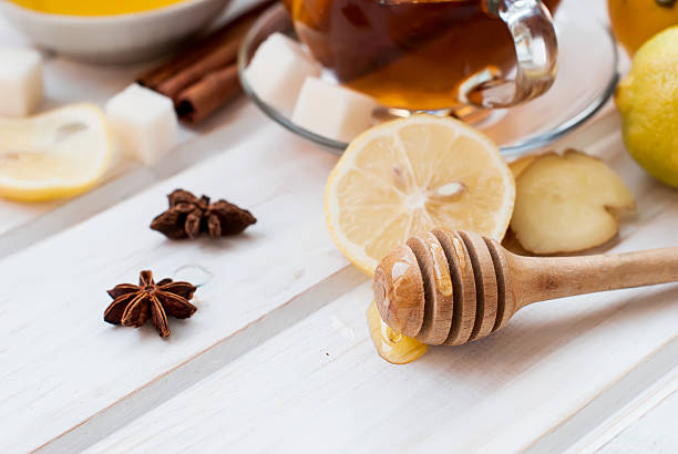istock Spoon with honey on a table and a cup of tea 494342020