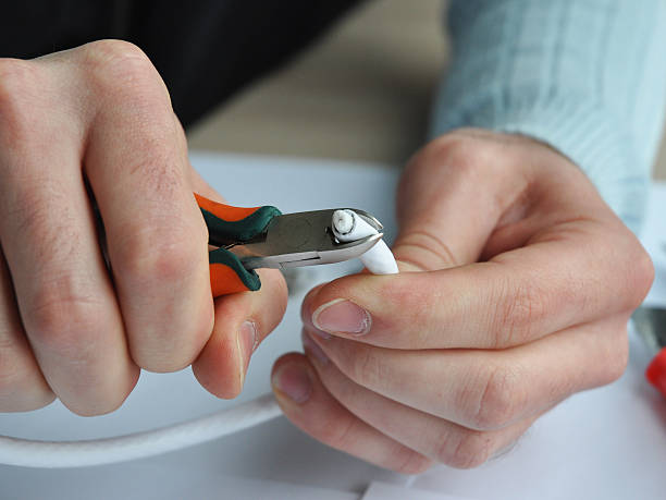 istock TV cable to transmit satellite signals in hands. 494342096