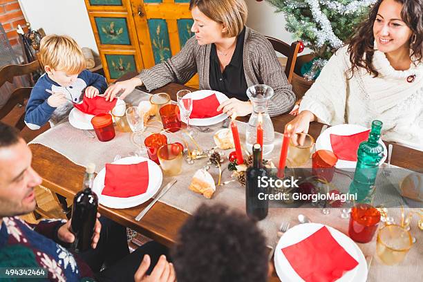 Family Gathers For Christmas Dinner Stock Photo - Download Image Now - 2015, Adult, Child