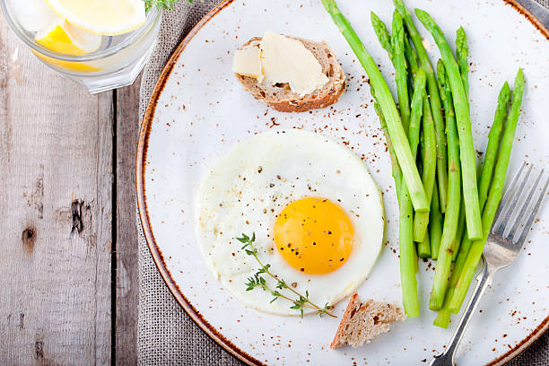 istock Green asparagus,fried egg and bread with butter. 494345656
