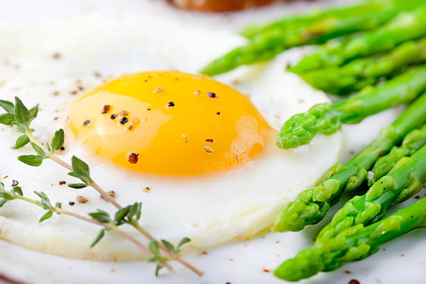istock Green asparagus,fried egg and bread with butter. 494345728