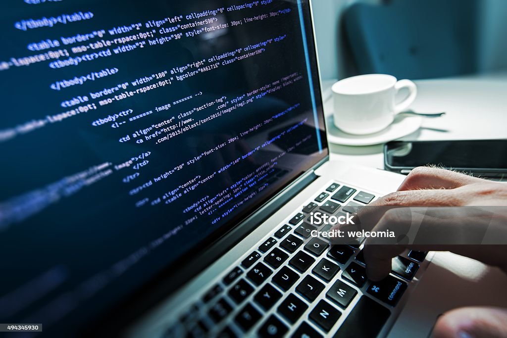 Programming Works Programming Work Time. Programmer Typing New Lines of HTML Code. Laptop and Hand Closeup. Working Time. Web Design Business Concept. Close-up Stock Photo